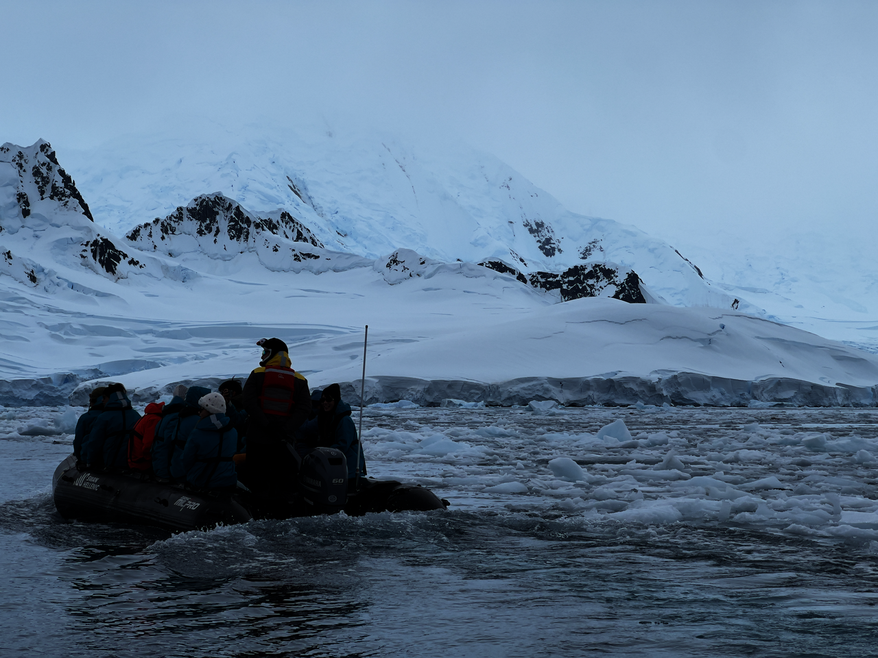 Zodiac inflatable boat navigating through brash ice in the Antarctic Peninsula during an expedition cruise